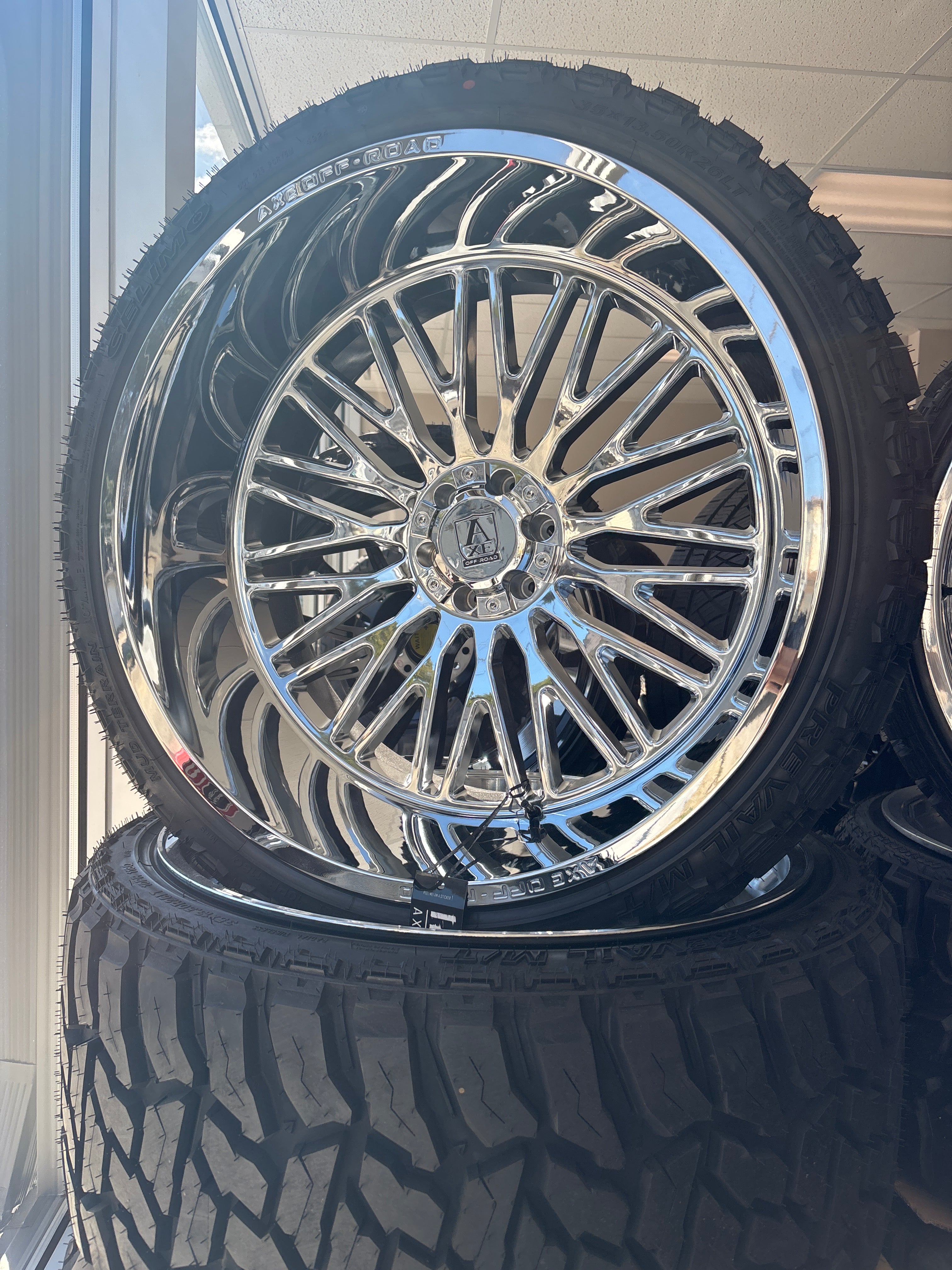 26x14 Axe Kratos Chrome 6x5.5/ 6x135 & 35x13.50R26 Celimo MT