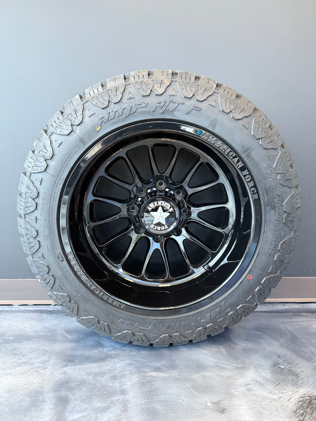 20x12 American Force Nemesis CC Gloss Black 8x180 & 33x12.50R20 AMP AT PRO - Blowout