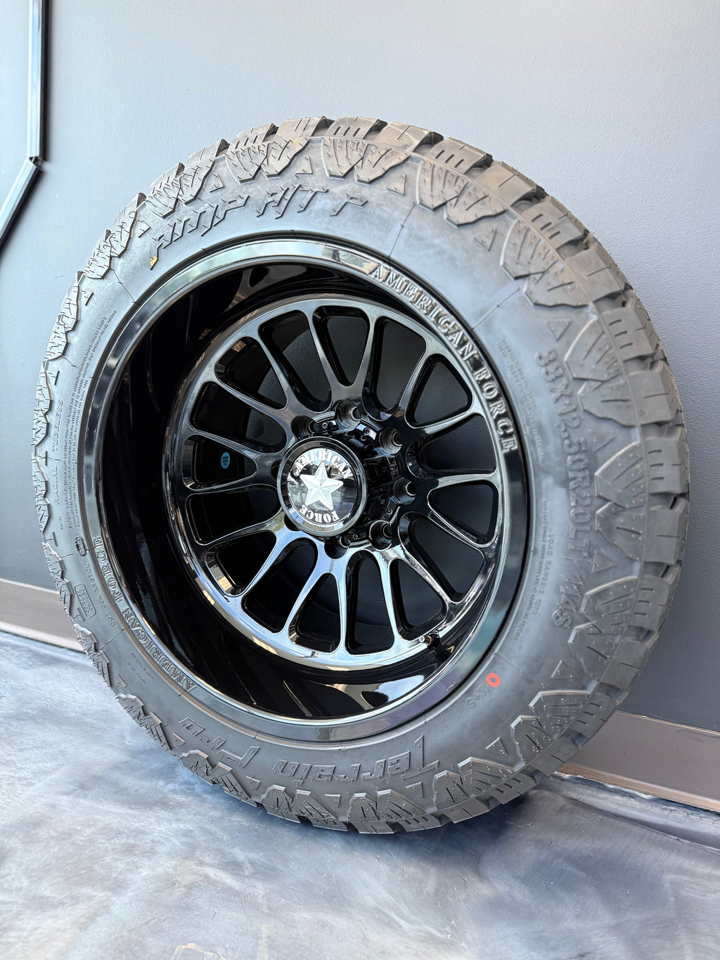 20x12 American Force Nemesis CC Gloss Black 8x180 & 33x12.50R20 AMP AT PRO - Blowout